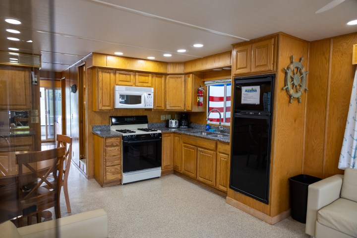 a modern kitchen with stainless steel appliances and wooden cabinets