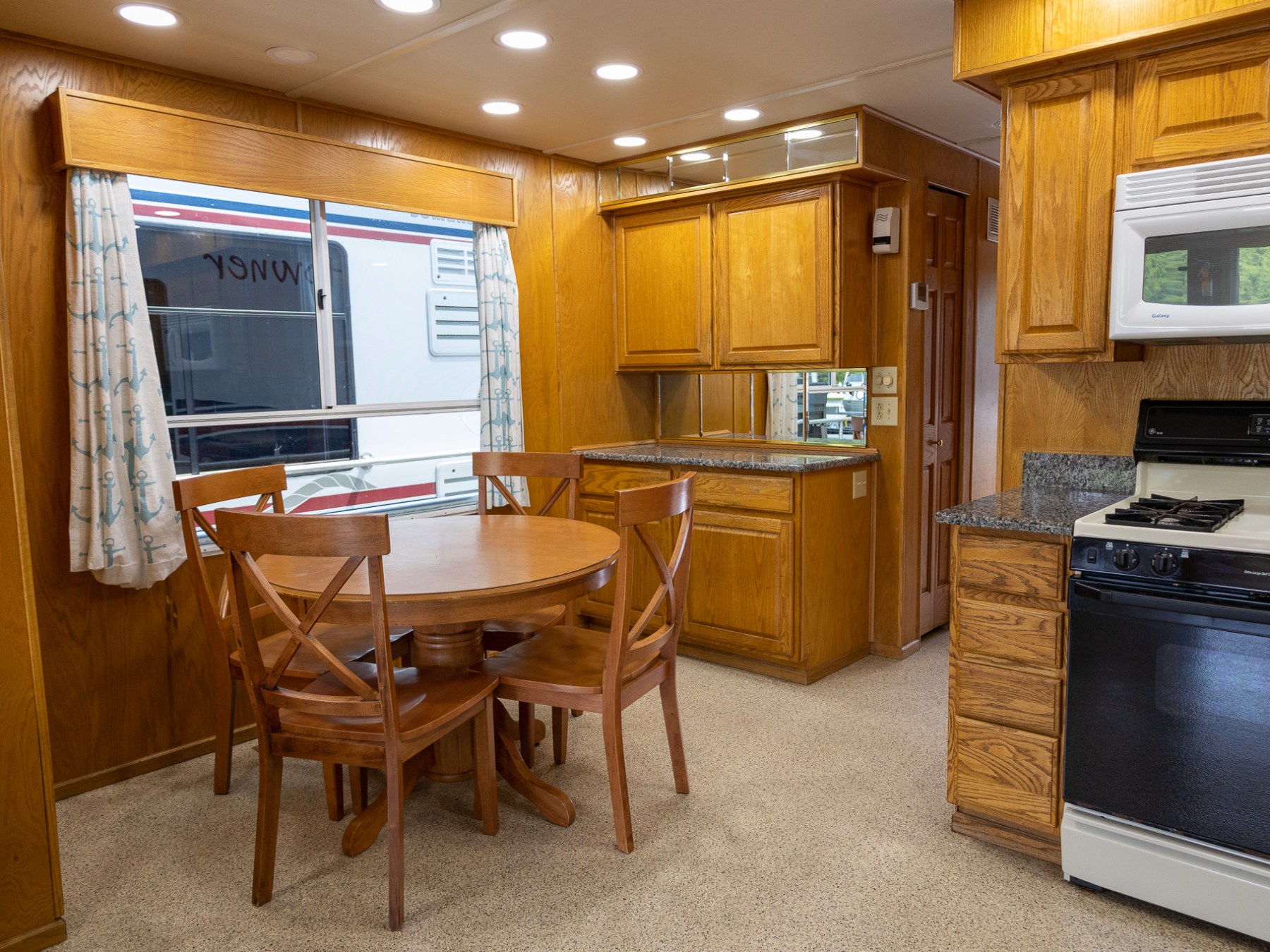 a kitchen with a stove top oven sitting inside of a room