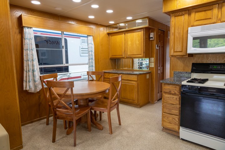 a kitchen with a stove top oven sitting inside of a room