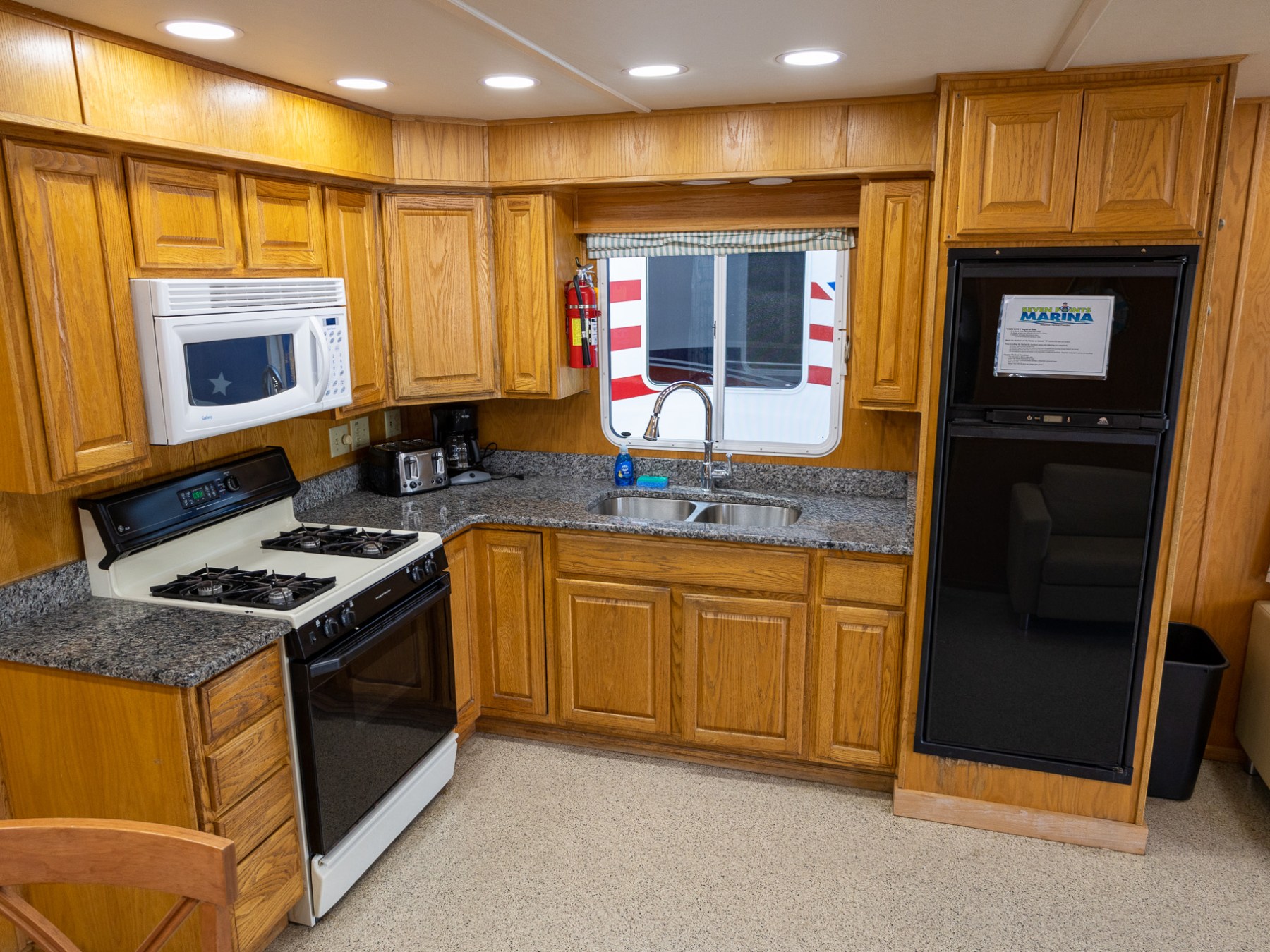 a kitchen with a microwave on top of a wooden floor