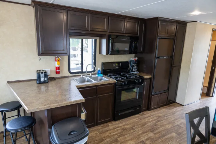 a kitchen with a stove top oven sitting inside of a room