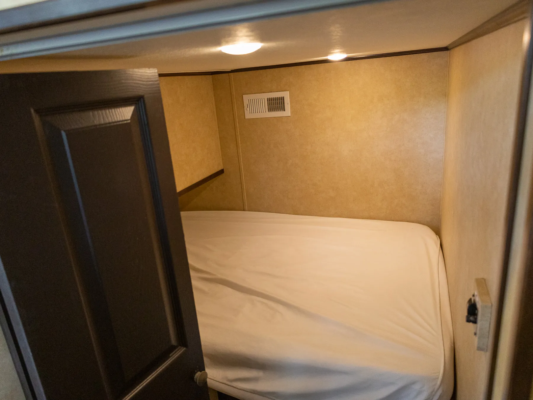 a bedroom with a bed and a mirror