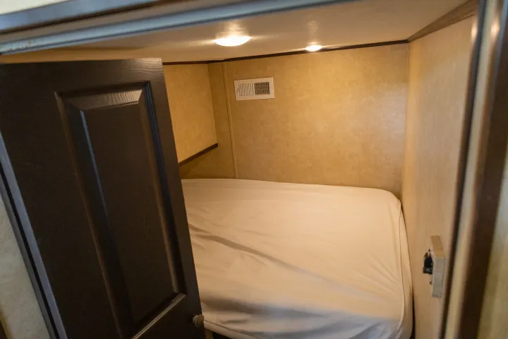 a bedroom with a bed and a mirror