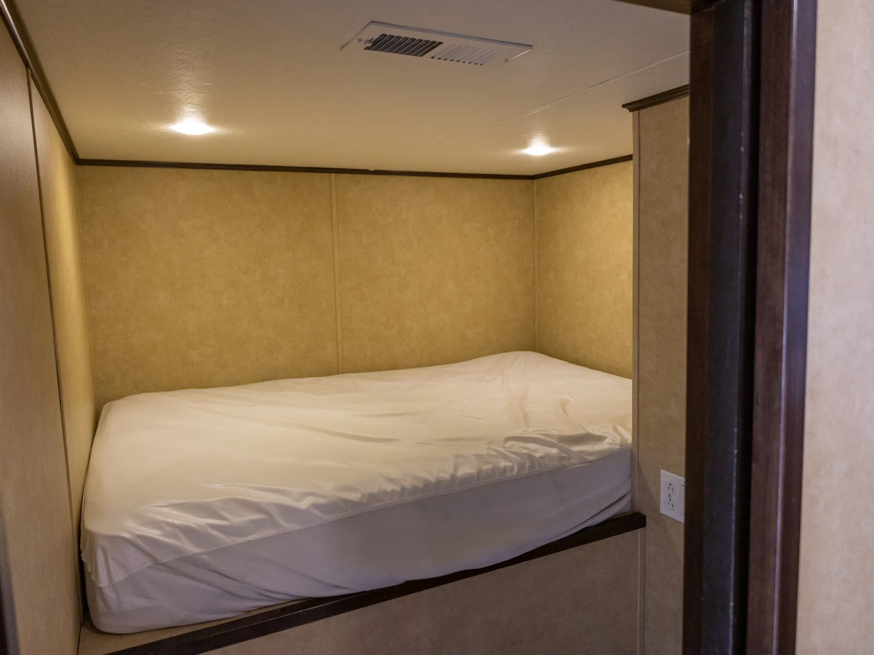 a bedroom with a bed and a mirror