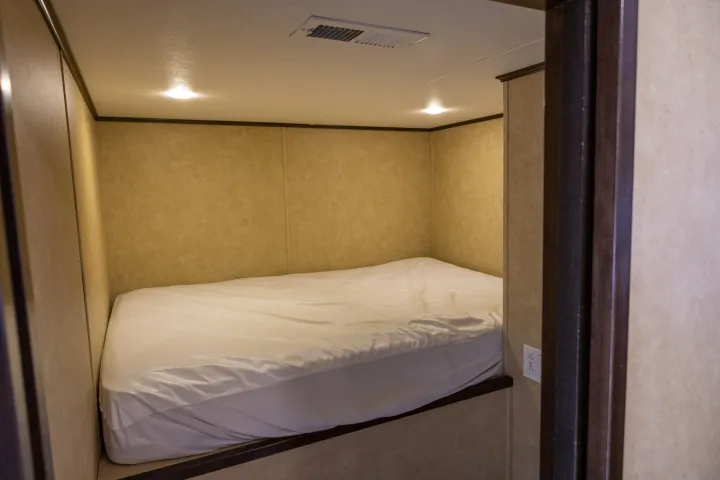 a bedroom with a bed and a mirror