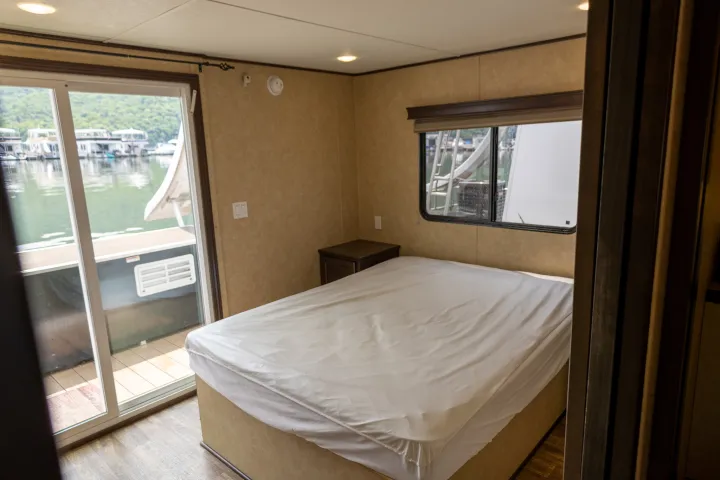 a bedroom with a bed and a window