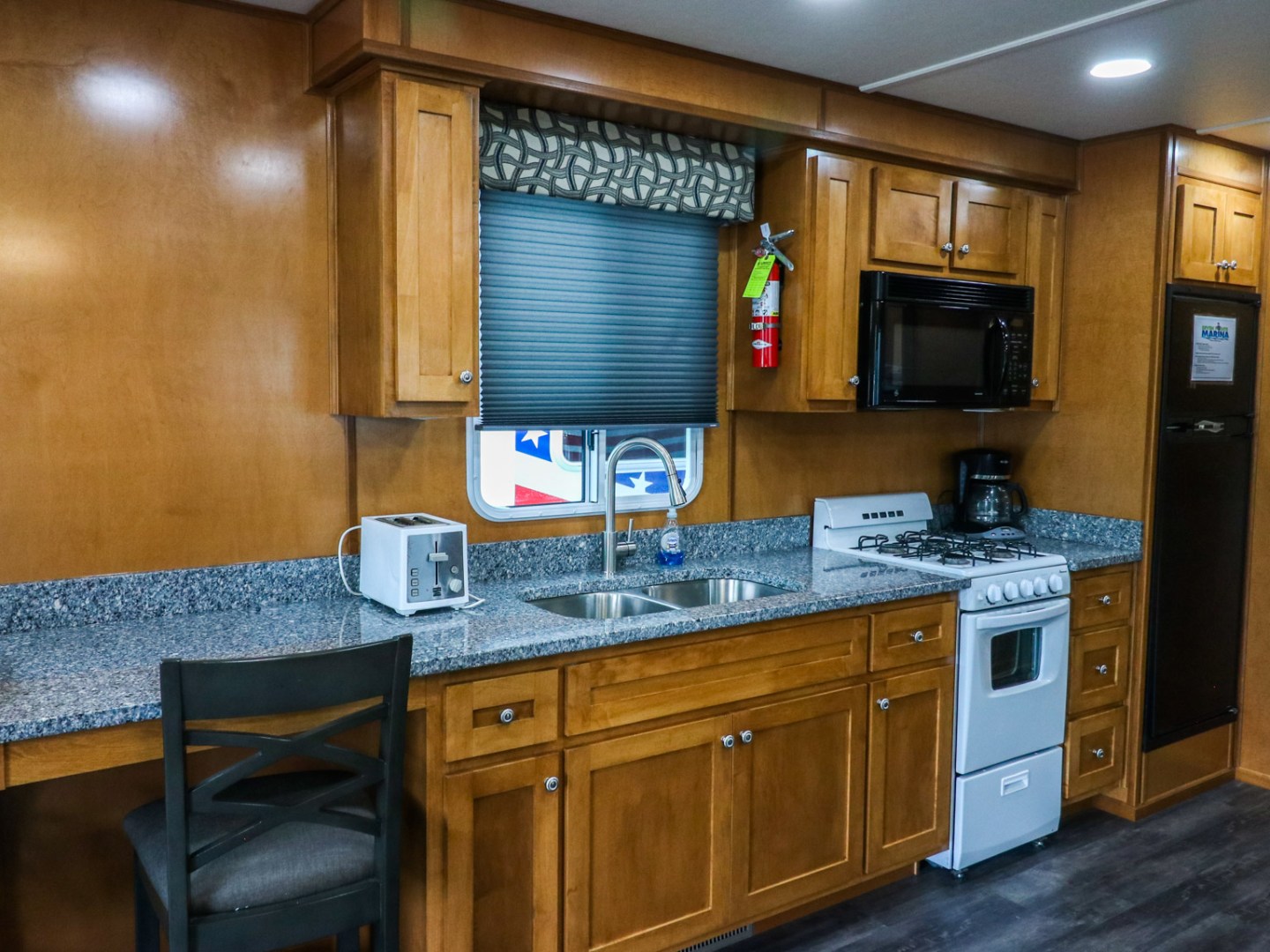 a kitchen with a stove top oven sitting inside of a room