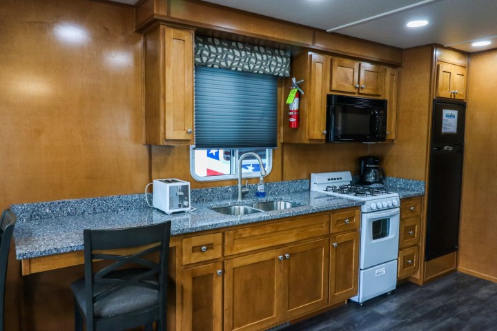 a kitchen with a stove top oven sitting inside of a room