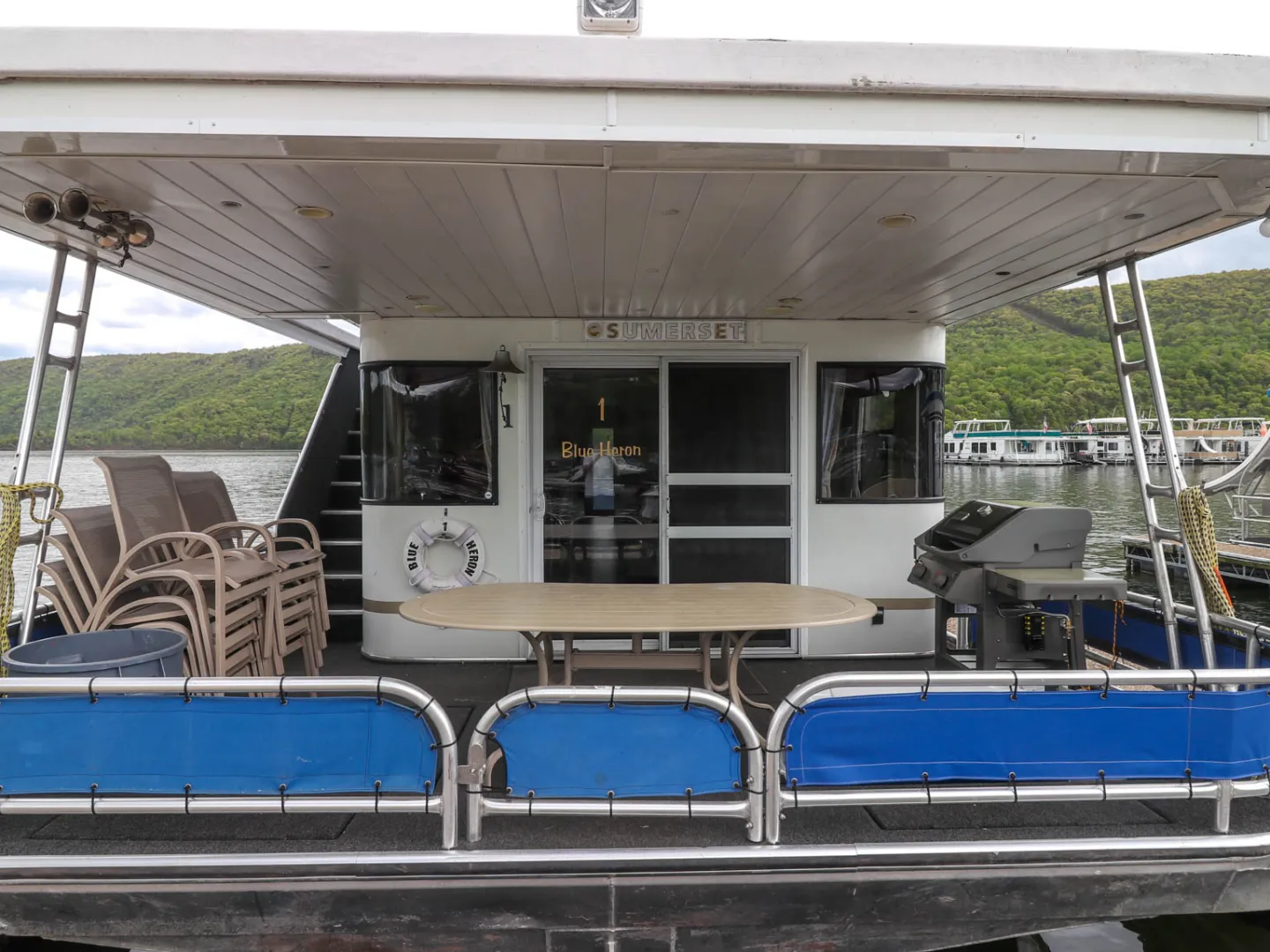 a blue and white boat parked at a dock