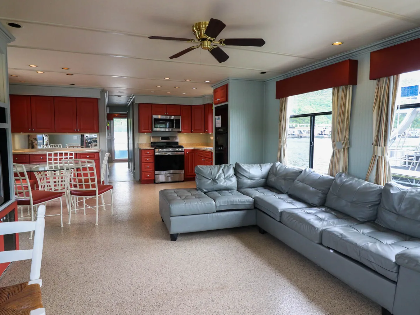 a living room filled with furniture and a large window
