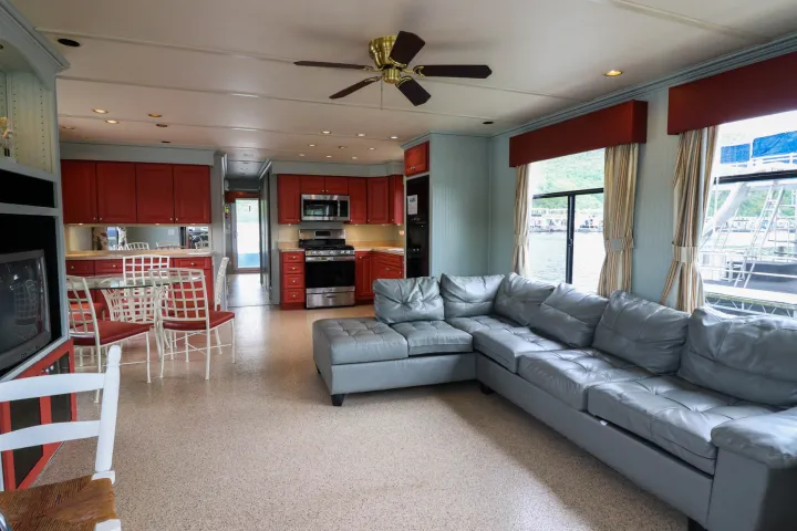 a living room filled with furniture and a large window
