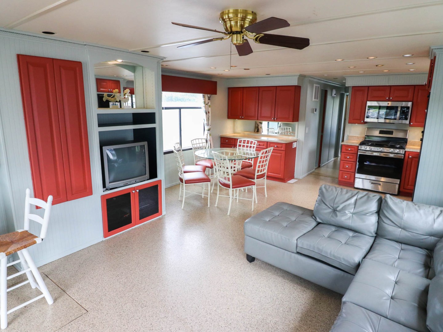 a living room filled with furniture and a tv