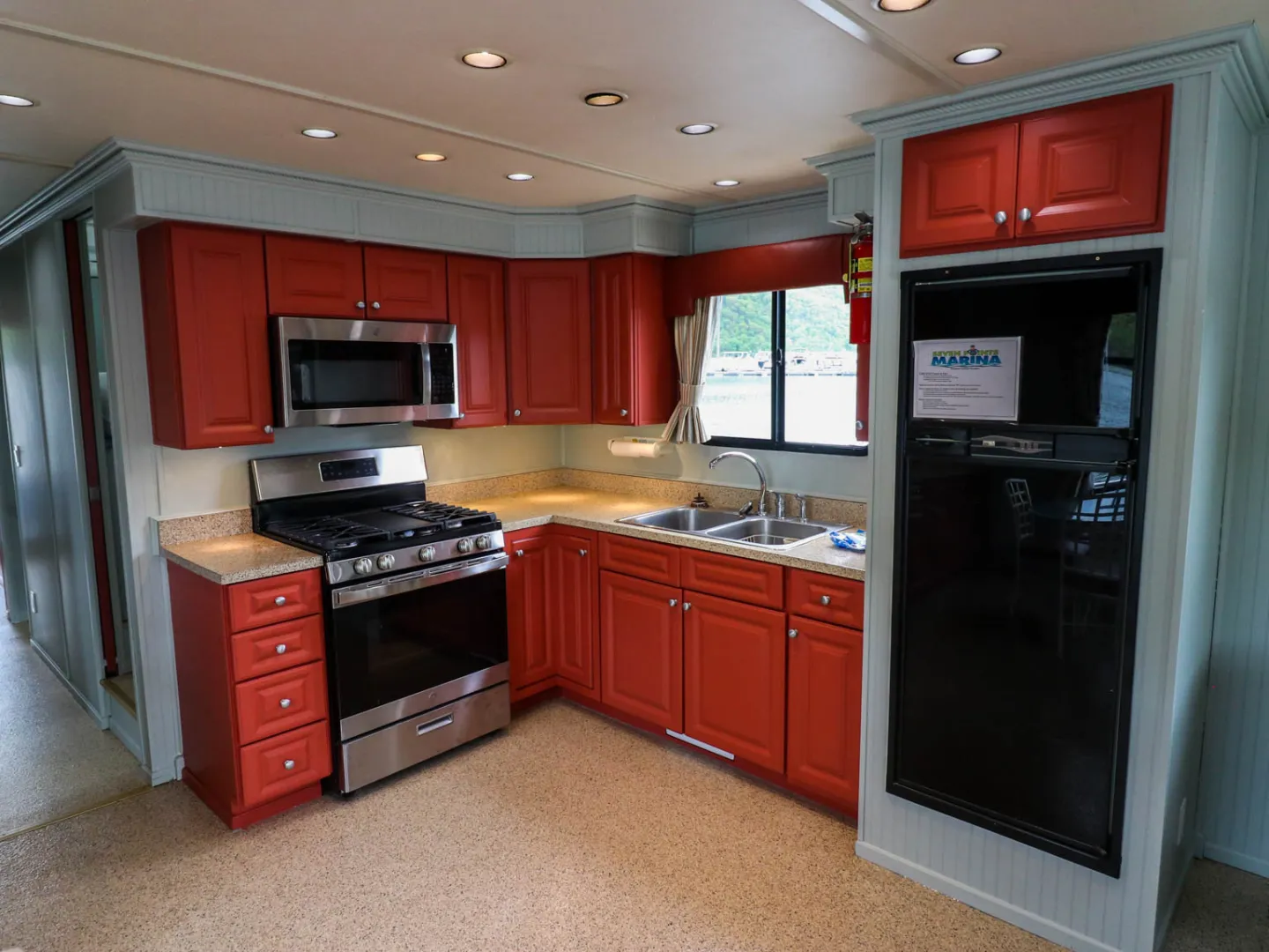 a kitchen with a stove top oven sitting inside of a room