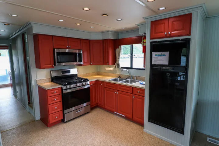 a kitchen with a stove top oven sitting inside of a room