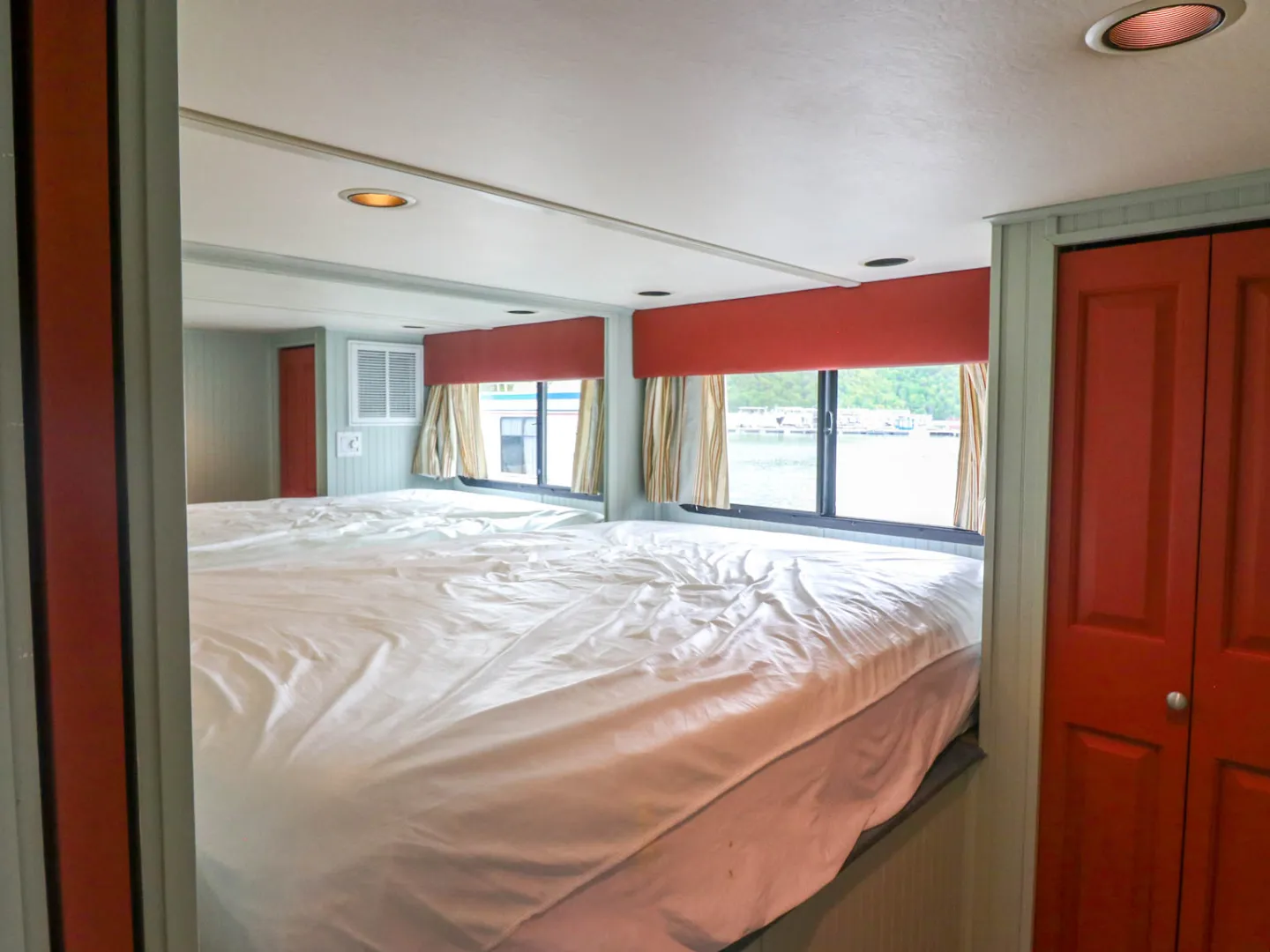 a bedroom with a bed and a mirror