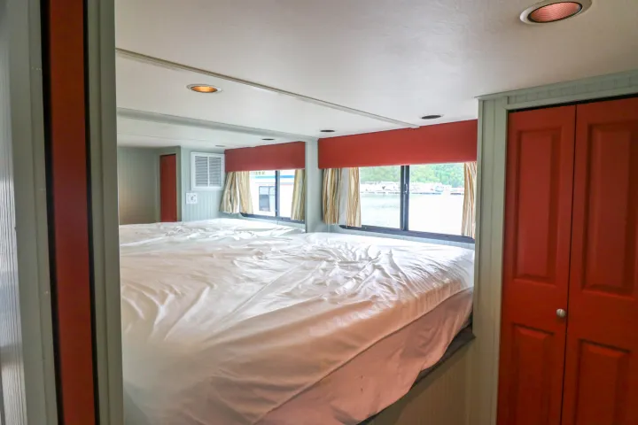 a bedroom with a bed and a mirror