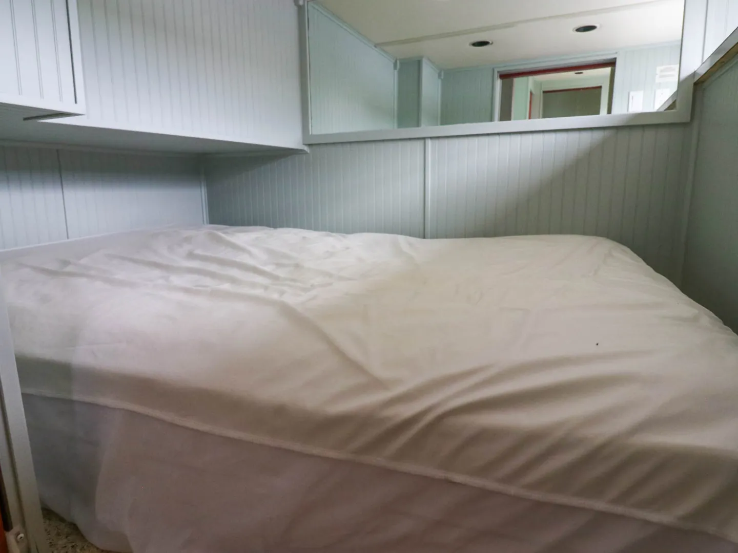 a bedroom with a bed in a room