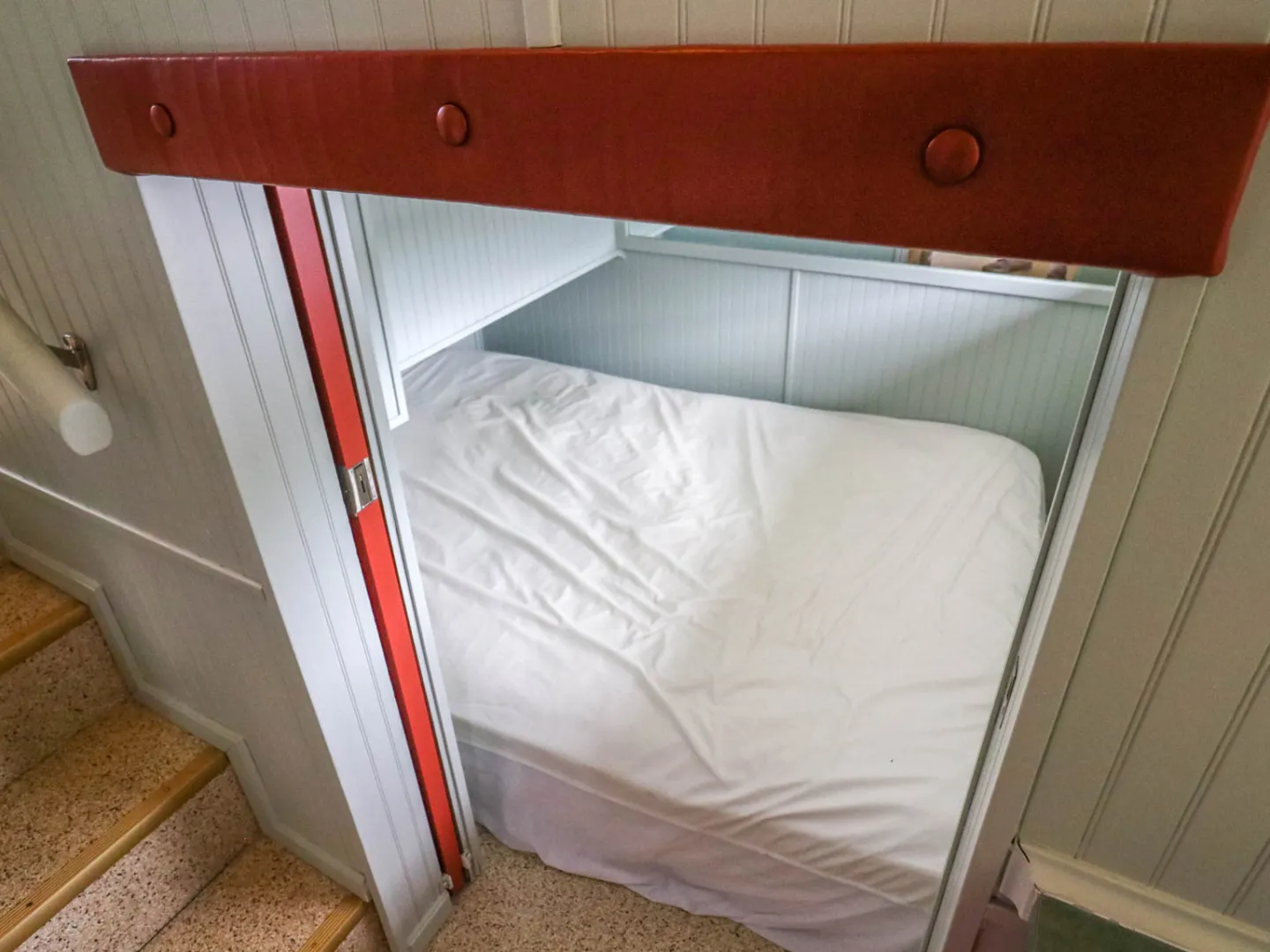 a bedroom with a bed and a mirror