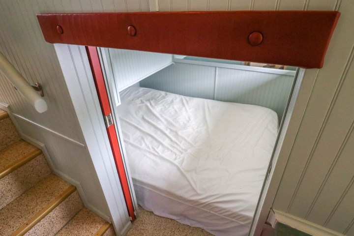 a bedroom with a bed and a mirror