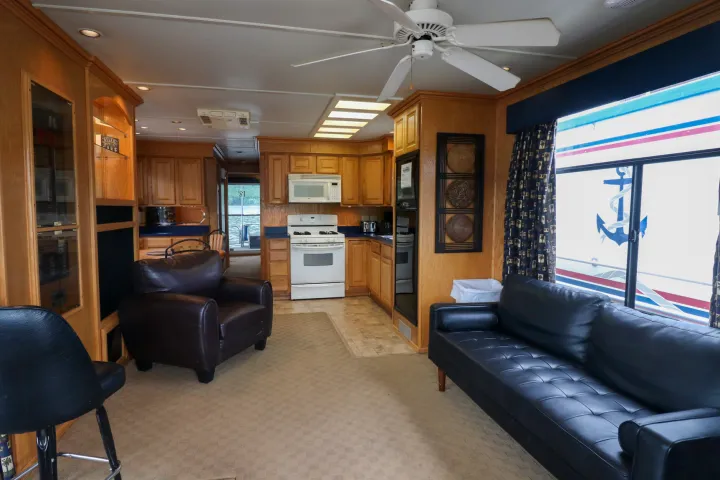 a living room filled with furniture and a large window