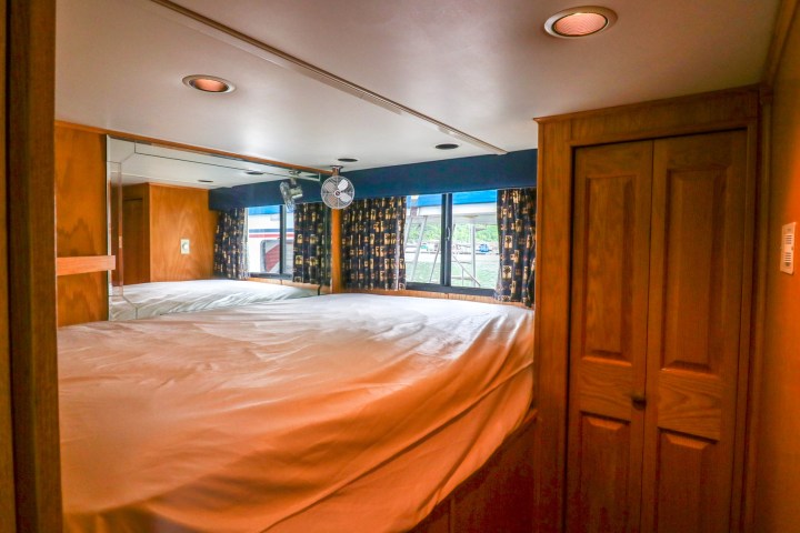 a bedroom with a bed and a mirror