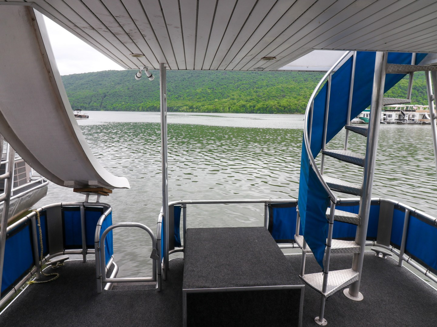 a blue chair next to a body of water