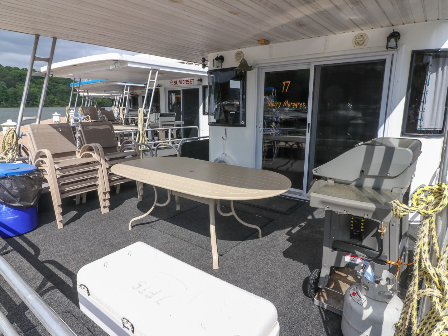 a group of people sitting at a table with a blue umbrella