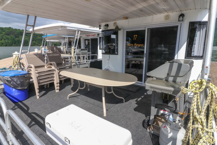 a group of people sitting at a table with a blue umbrella