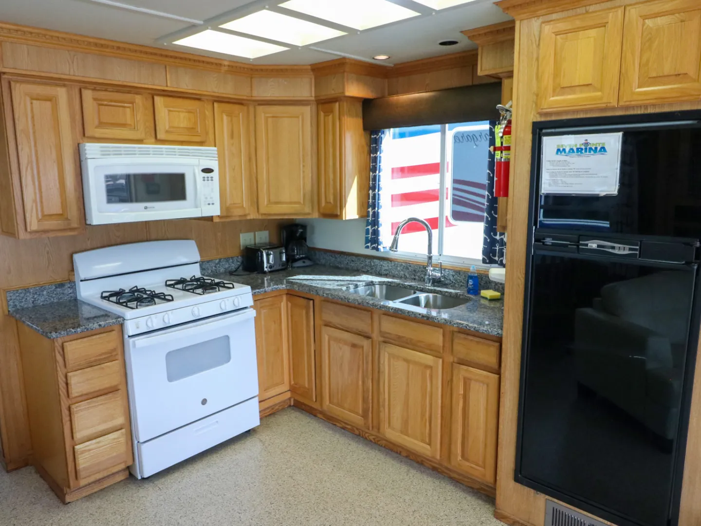 a kitchen with wooden cabinets and a microwave