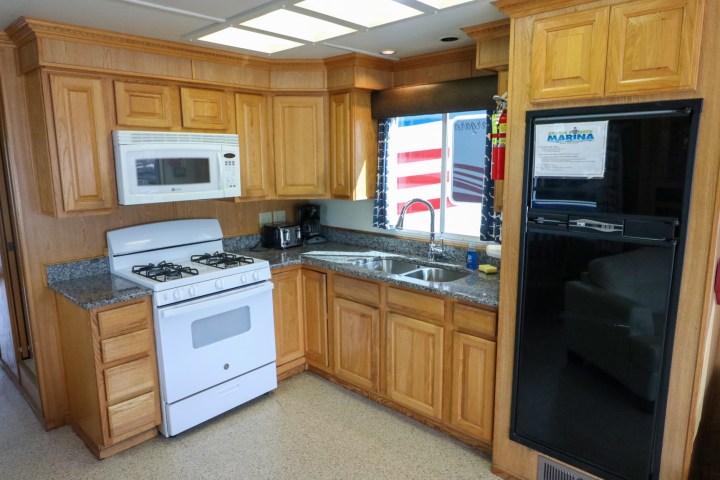 a kitchen with wooden cabinets and a microwave