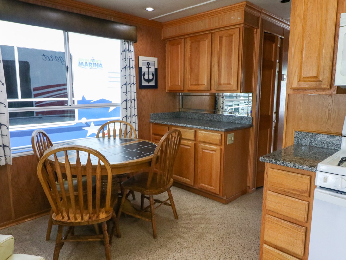 a kitchen with wooden cabinets and a dining room table