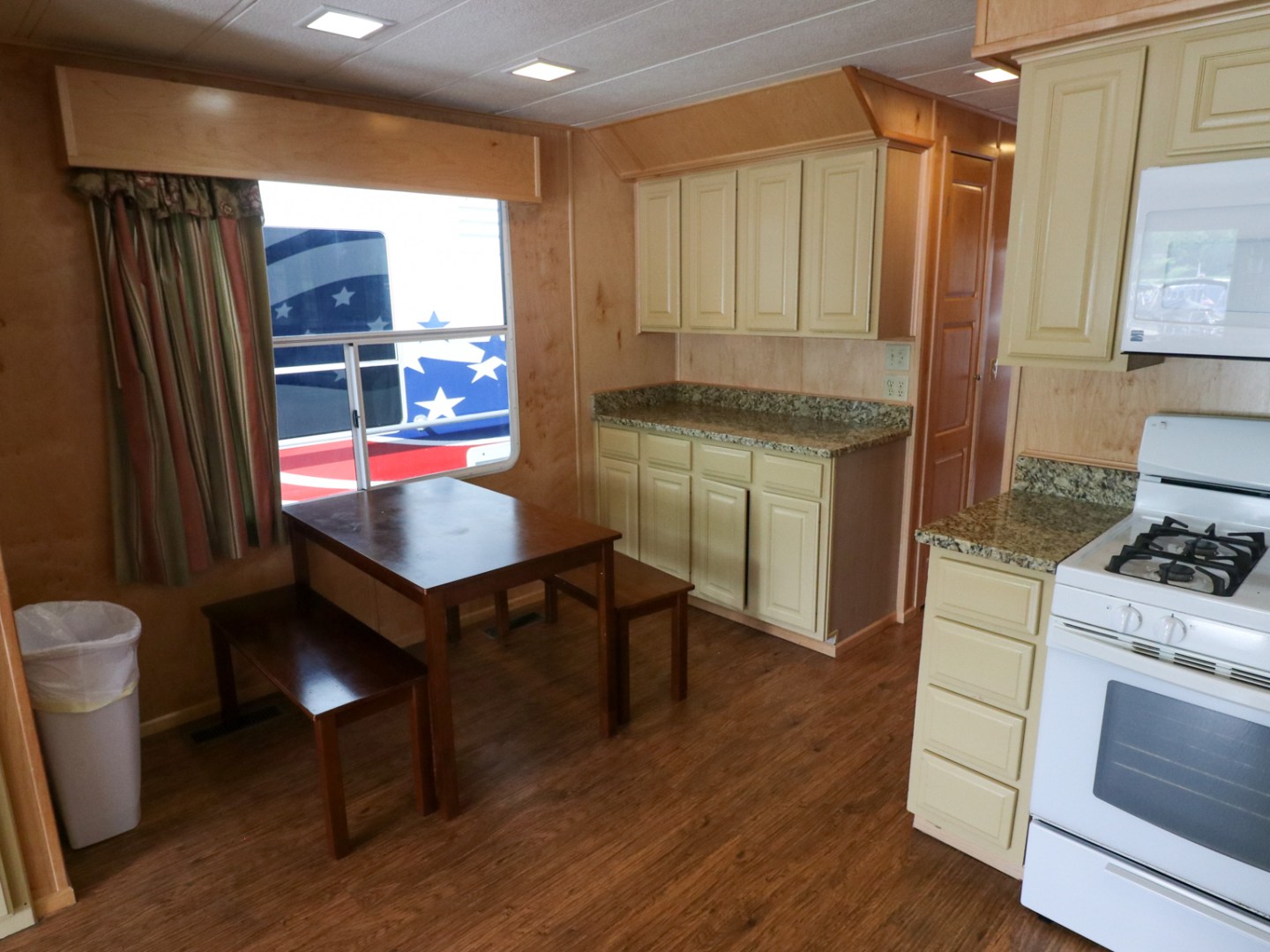 a kitchen with a stove top oven sitting next to a window