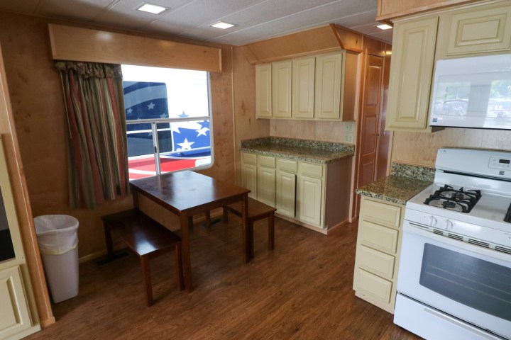 a kitchen with a stove top oven sitting next to a window