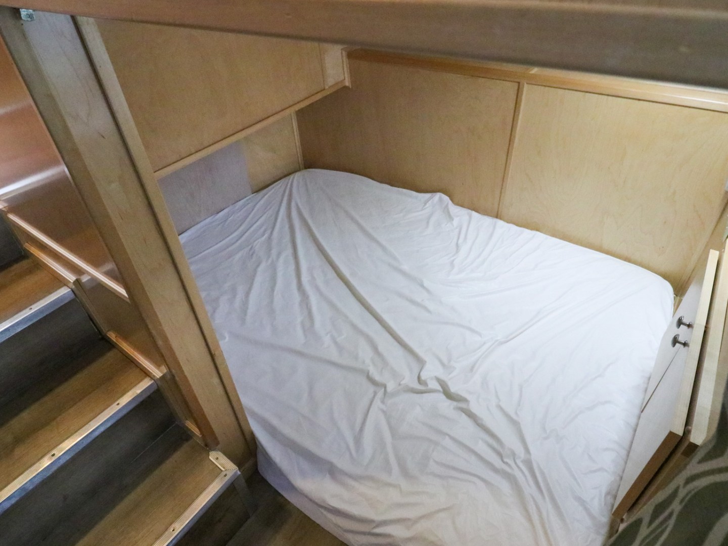 a bedroom with a bed and desk in a room