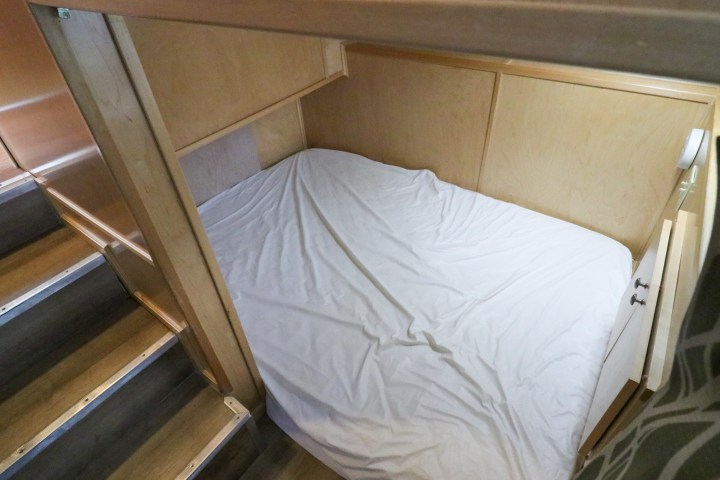 a bedroom with a bed and desk in a room