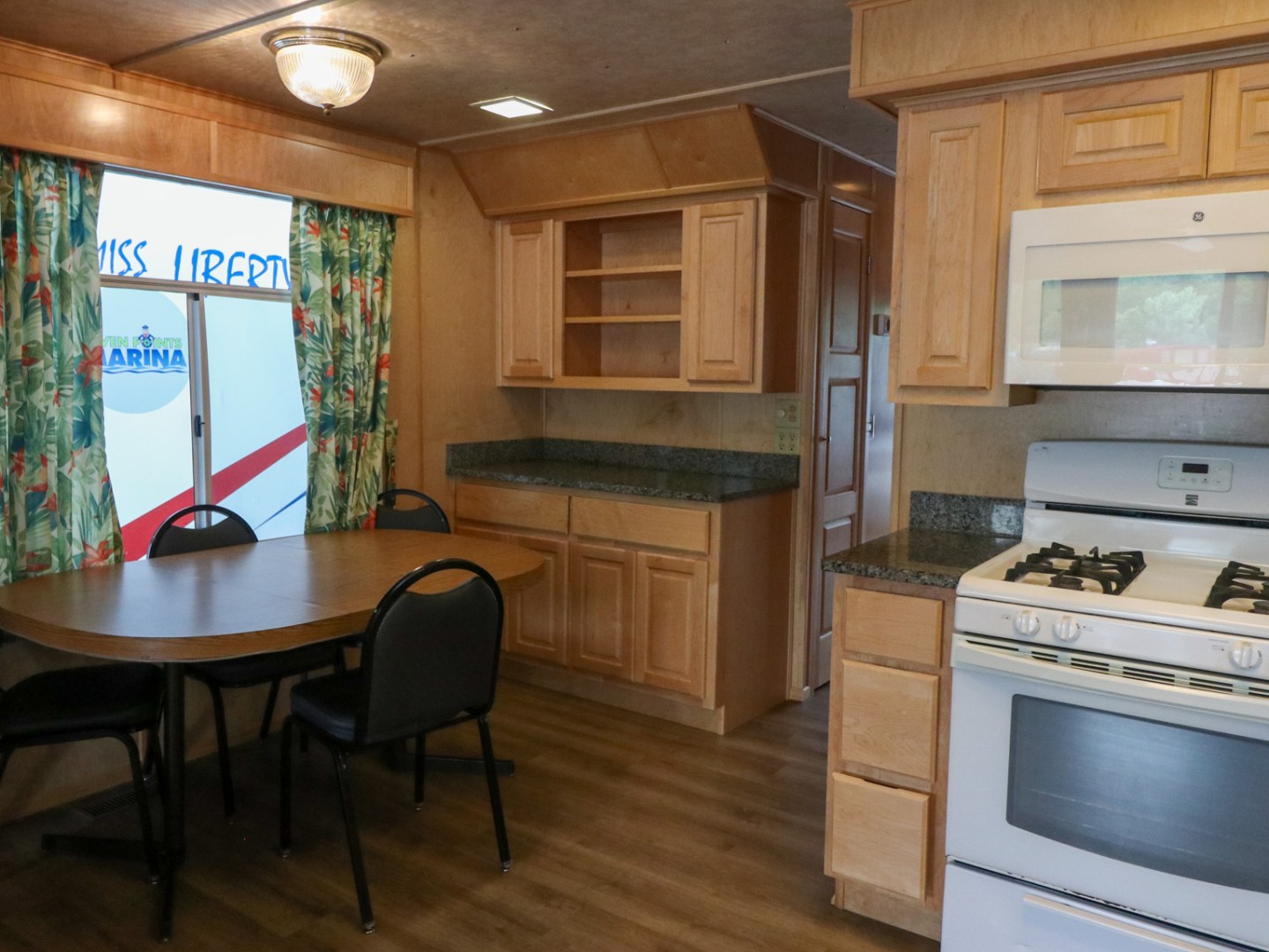 a kitchen with a stove top oven sitting inside of a room