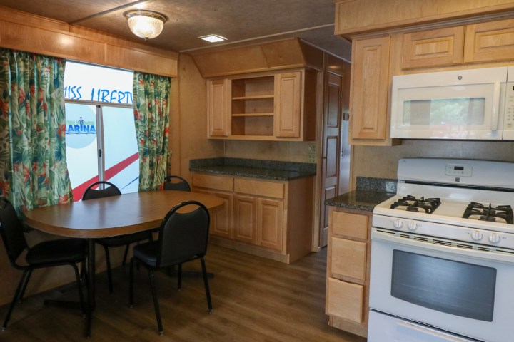a kitchen with a stove top oven sitting inside of a room