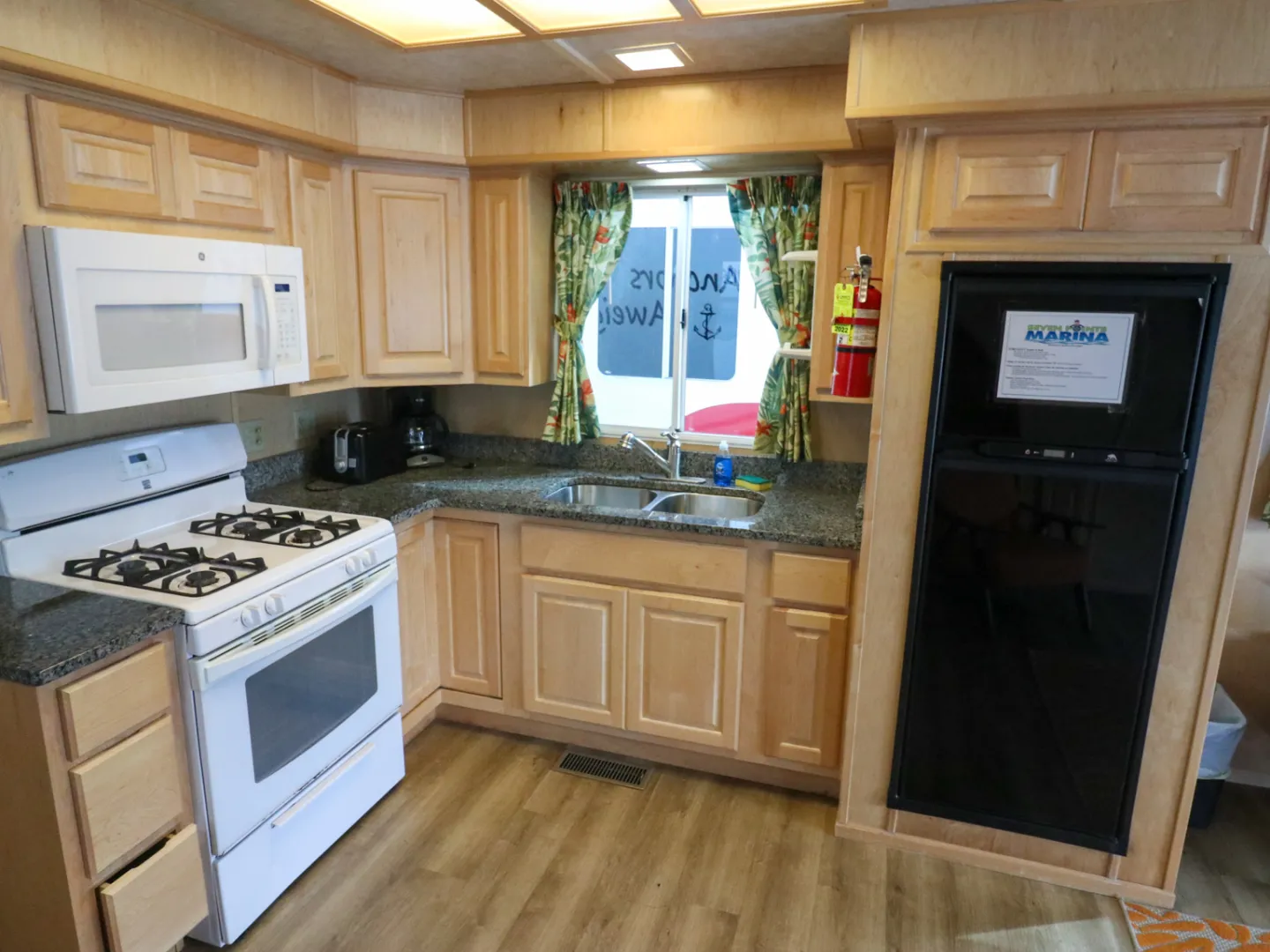 a stove top oven sitting inside of a kitchen