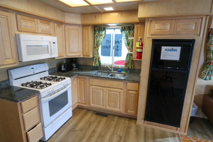 a stove top oven sitting inside of a kitchen