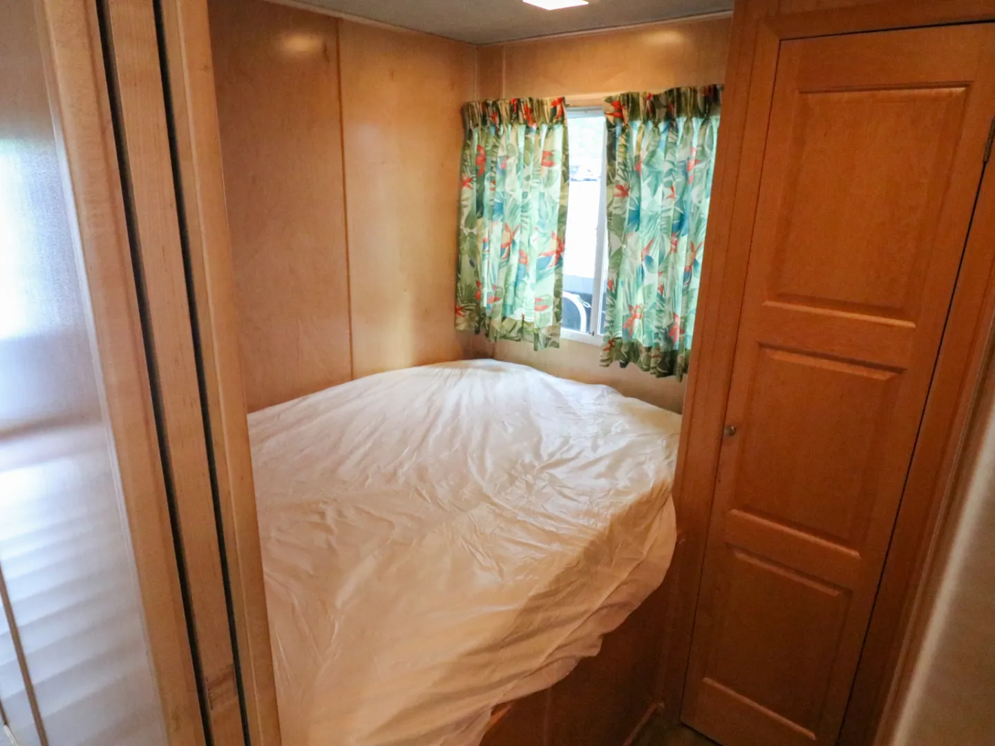 a bedroom with a bed and a mirror