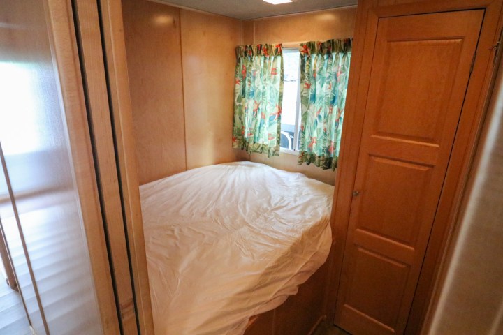 a bedroom with a bed and a mirror