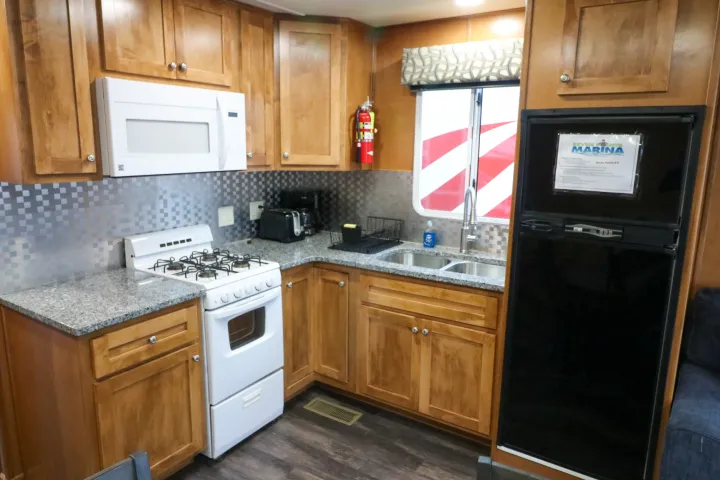 a kitchen with stainless steel appliances and wooden cabinets