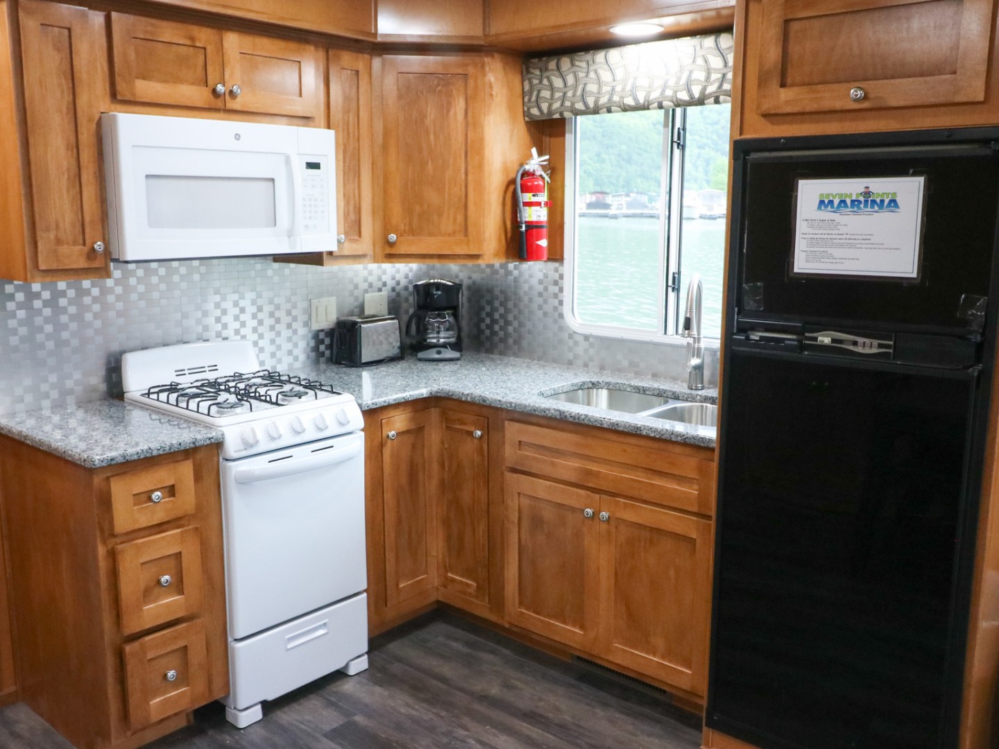 a kitchen with stainless steel appliances and wooden cabinets
