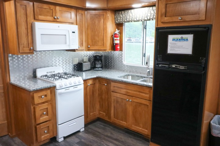 a kitchen with stainless steel appliances and wooden cabinets