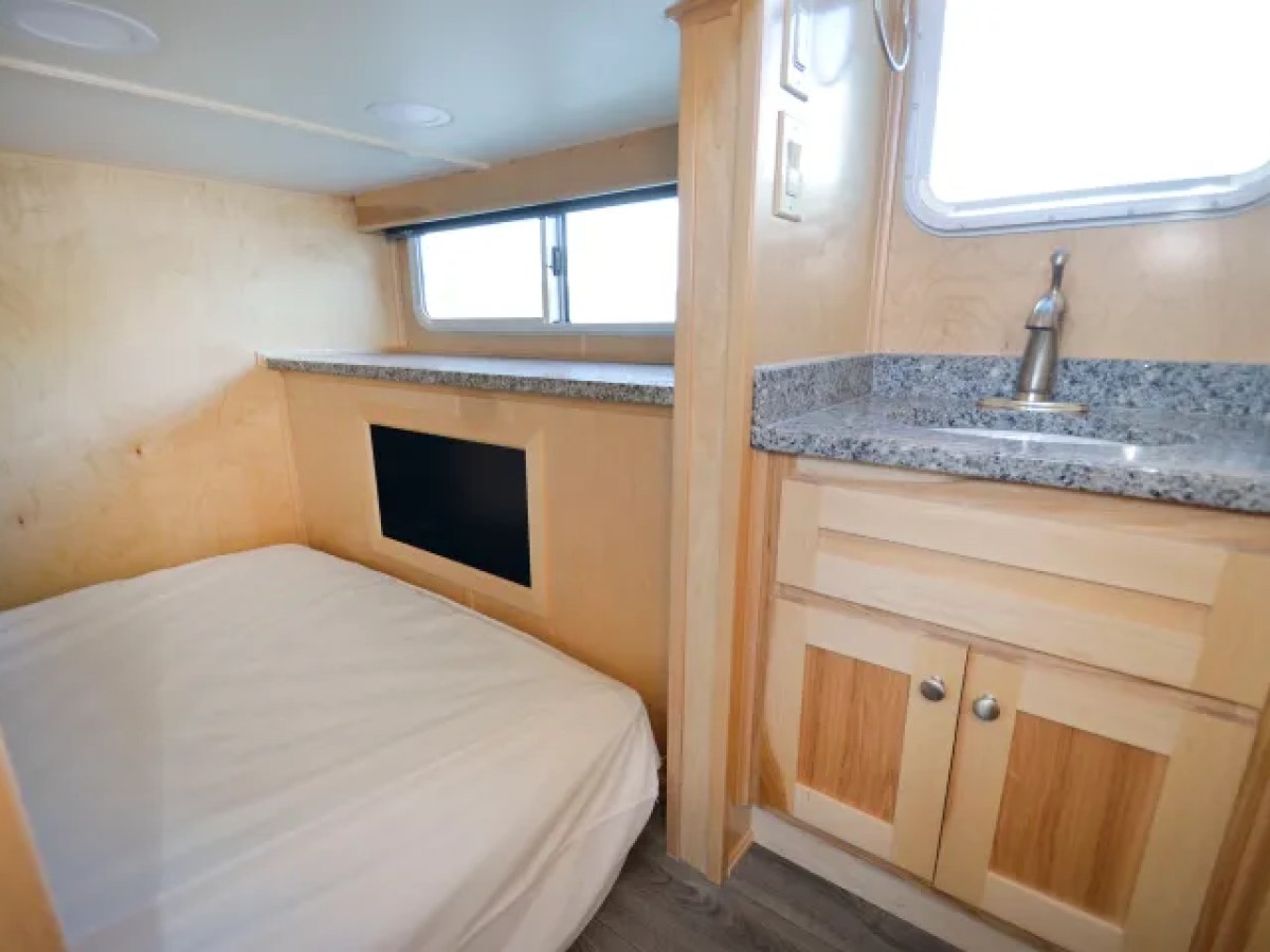 a bedroom with a bed and a sink