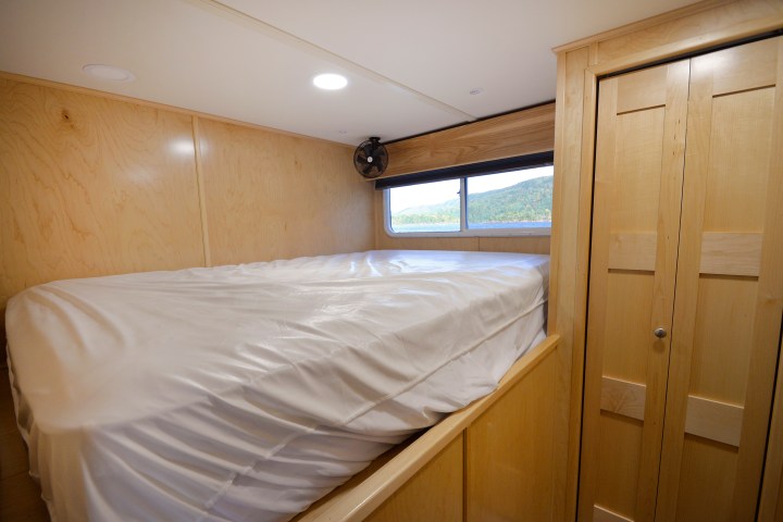 a bedroom with a bed and a mirror